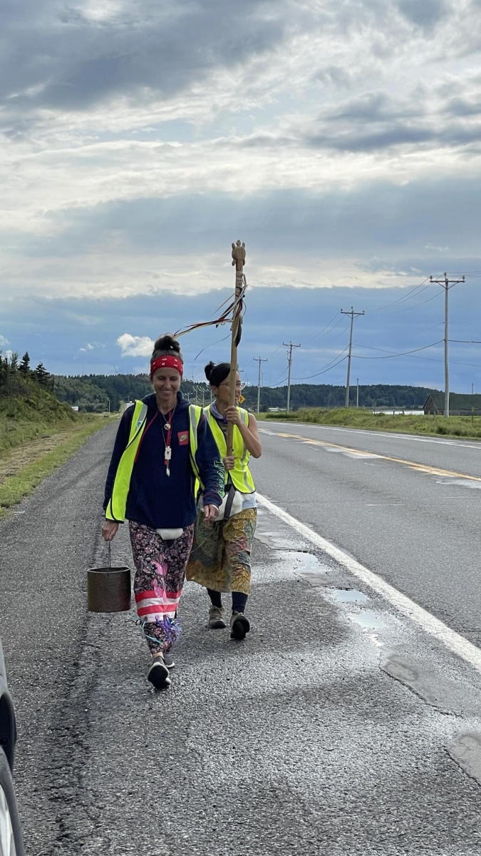 two walkers on the Water Walk, carrying the water pail and the staff