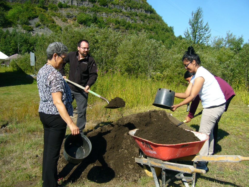 shovelling soil, planting an edible forest garden in Thunder Bay